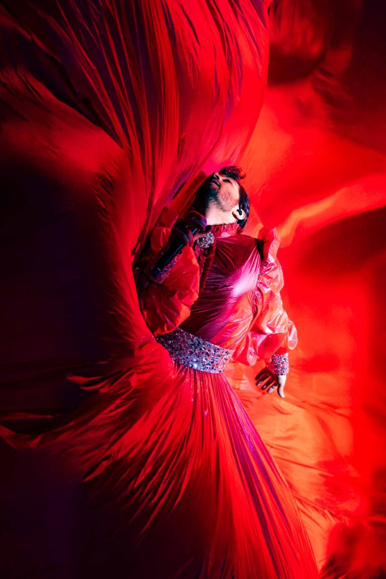 Ran Danker wrapped in flowing red fabric on stage